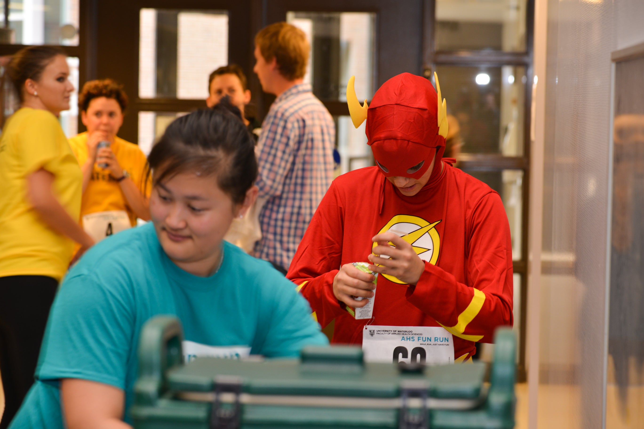 Student dressed as flash character getting a drink