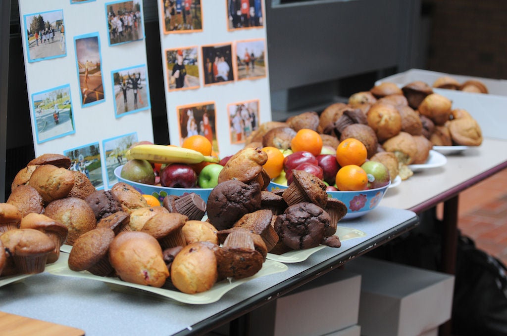 Various muffins and fruits on a table with a Fun Run photo hand-made poster