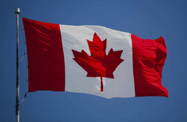 Canadian flag blowing in the wind.