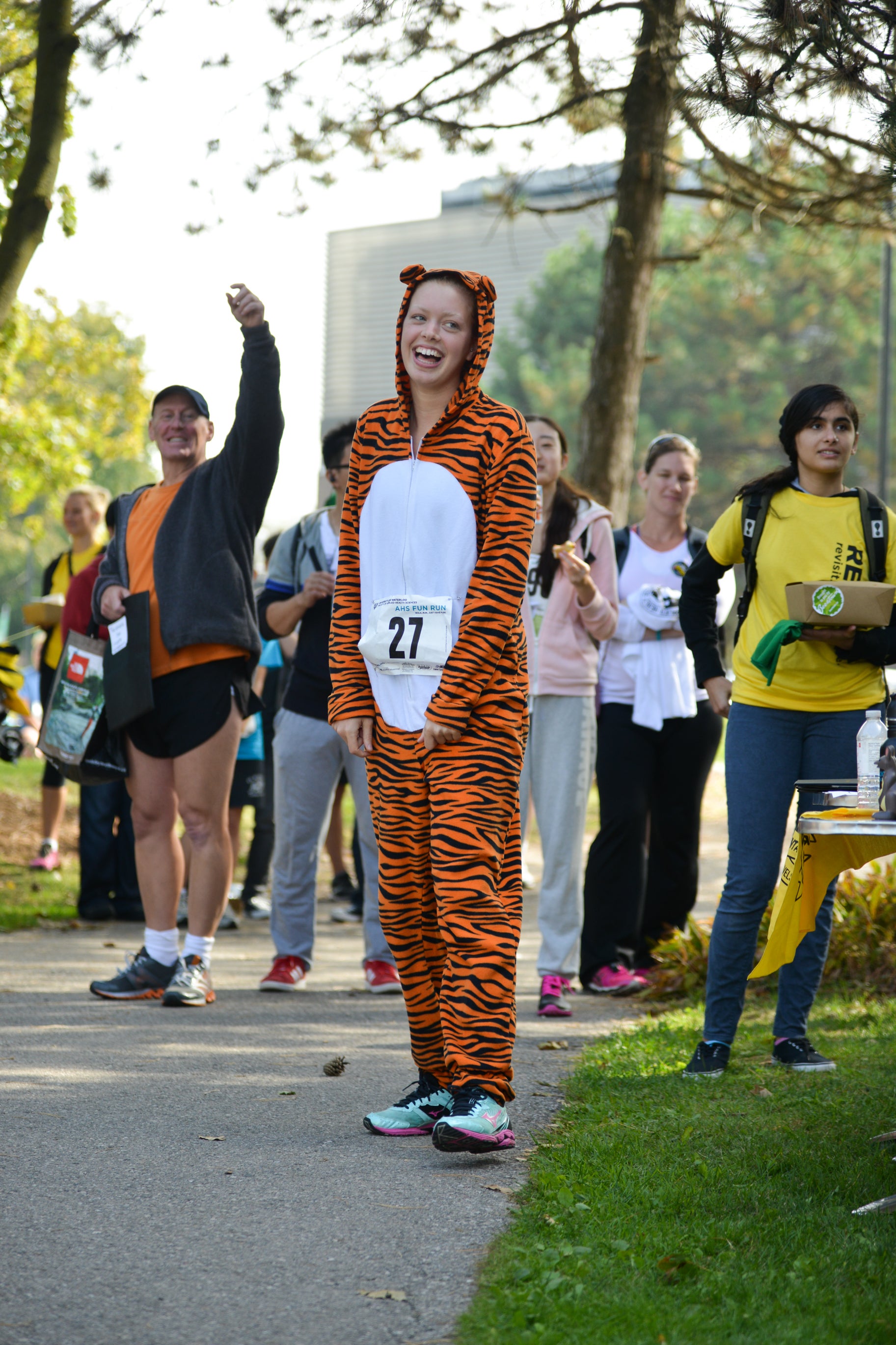 Lady wearing a tiger suit with participants in the background.