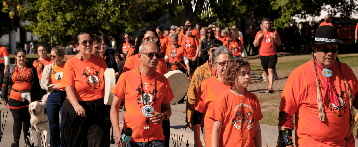 Group of UW staff, students and faculty walk Ring Road wearing orange shirts in support of the National Day for Truth and Reconciliation.