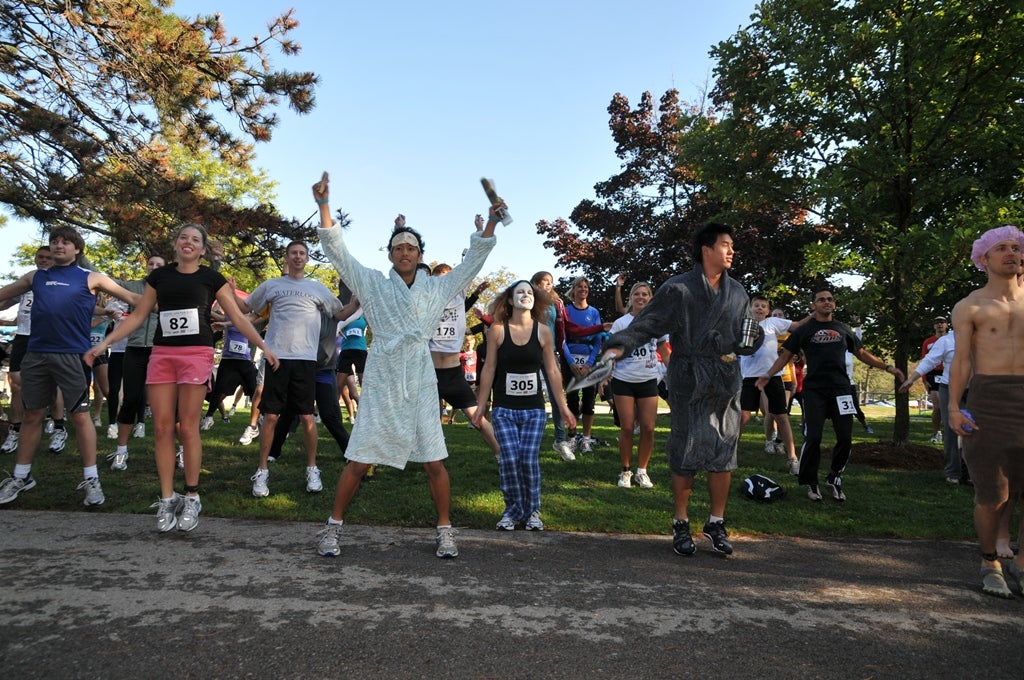Participants in various costumes warming up before the race
