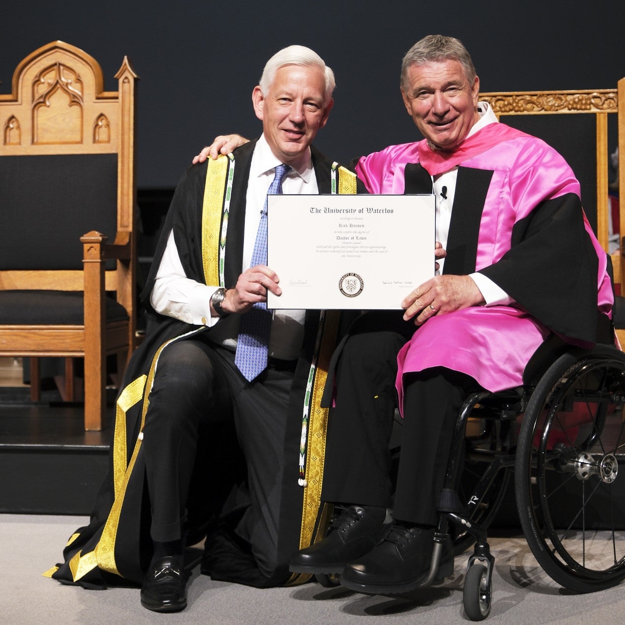 Rick Hansen receives his honorary doctorate diploma from Chancellor Dominic Barton