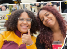 Two women smiling in stands