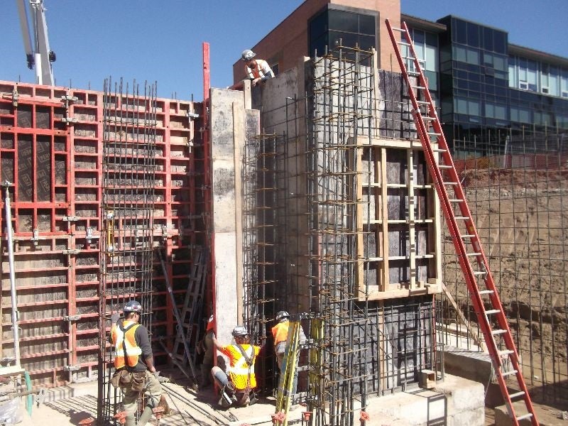 Construction workers installing formwork for the elevator.