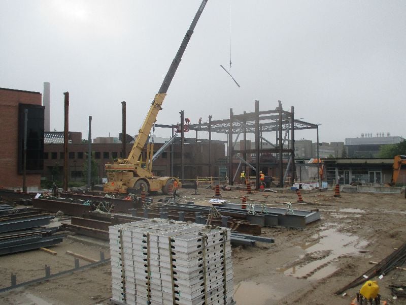 Construction workers erecting steel structure.