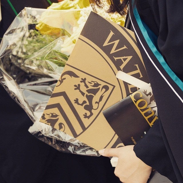 Diploma and flowers carried by grad.