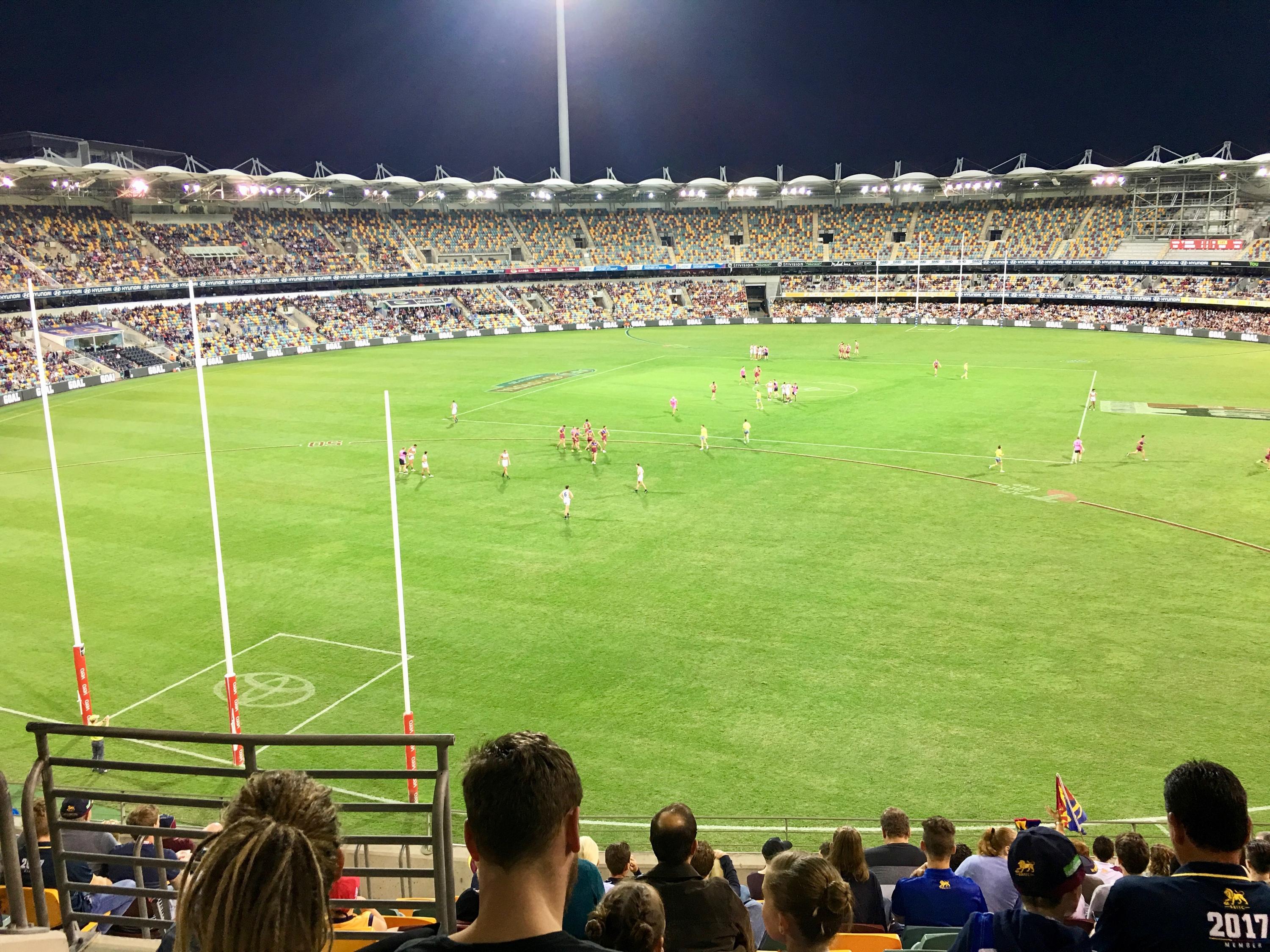 Stadium for australian football, filled with fans.