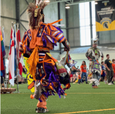 Wearing traditional clothing, an Indigenous person dances at a previous Pow Wow held at Waterloo.