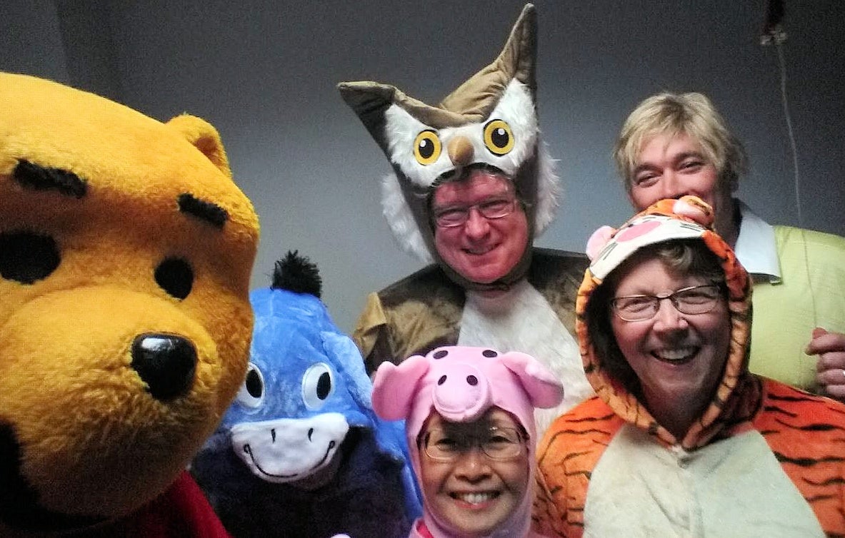 Six deans dressed as Winnie the Pooh characters.