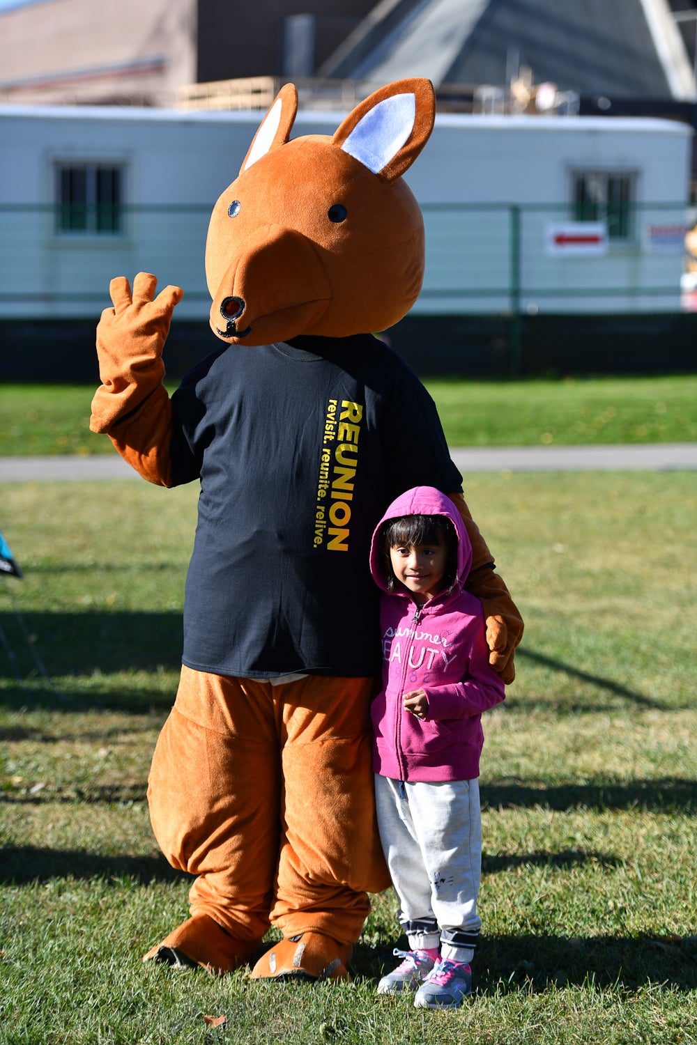 Child posing with AHSSIE, AHS' mascot