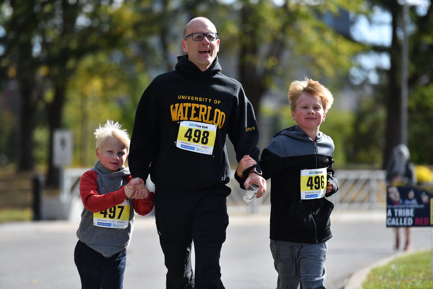 One father and two children running