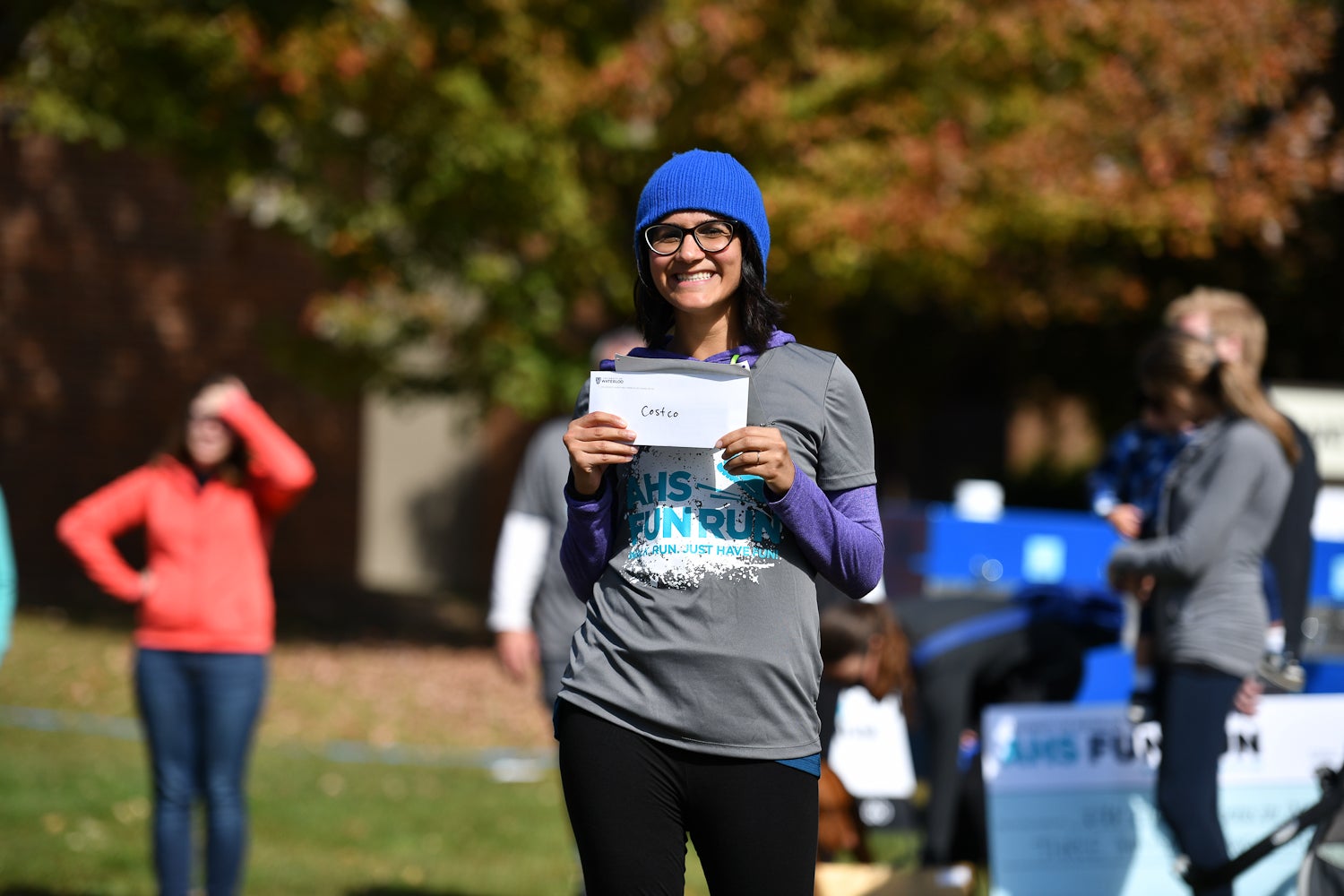 Fun Run prize winner smiling with envelope in hand