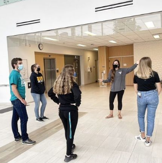 Four students getting a tour of the Expansion building