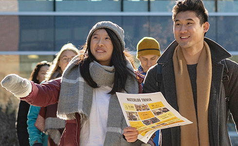 Students walking outside navigating campus.