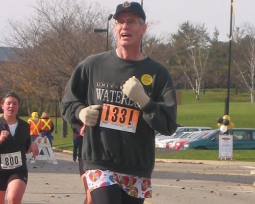 A man runnning wearing leggings and a skirt