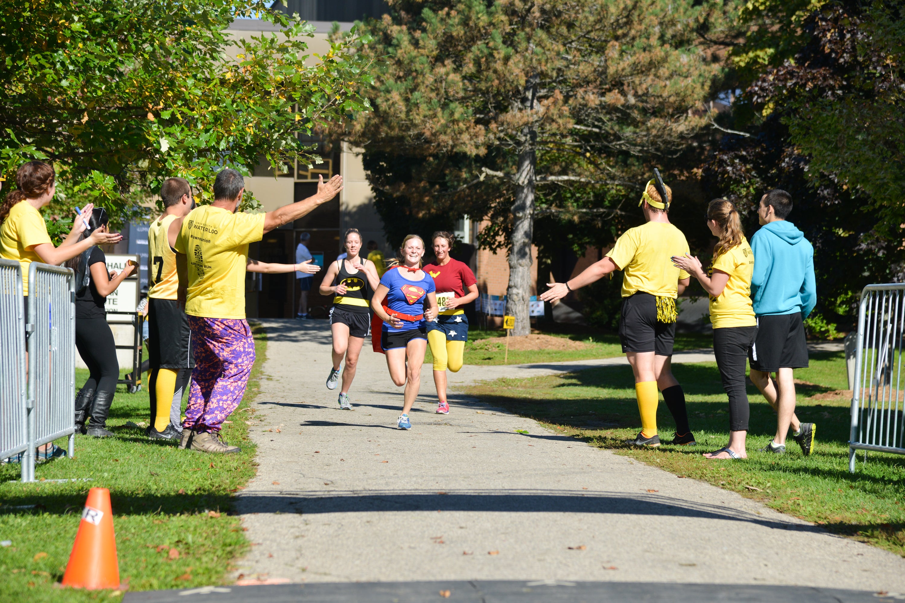 Participants dressed as super heroes passing the finish line