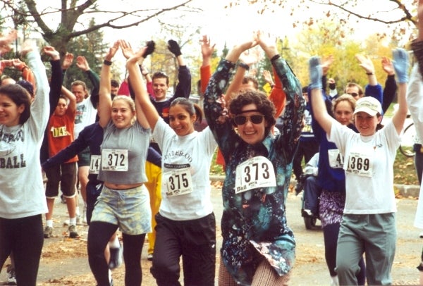 fun run participants stretching with arms in the air