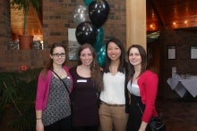 Four smiling students at send off reception.