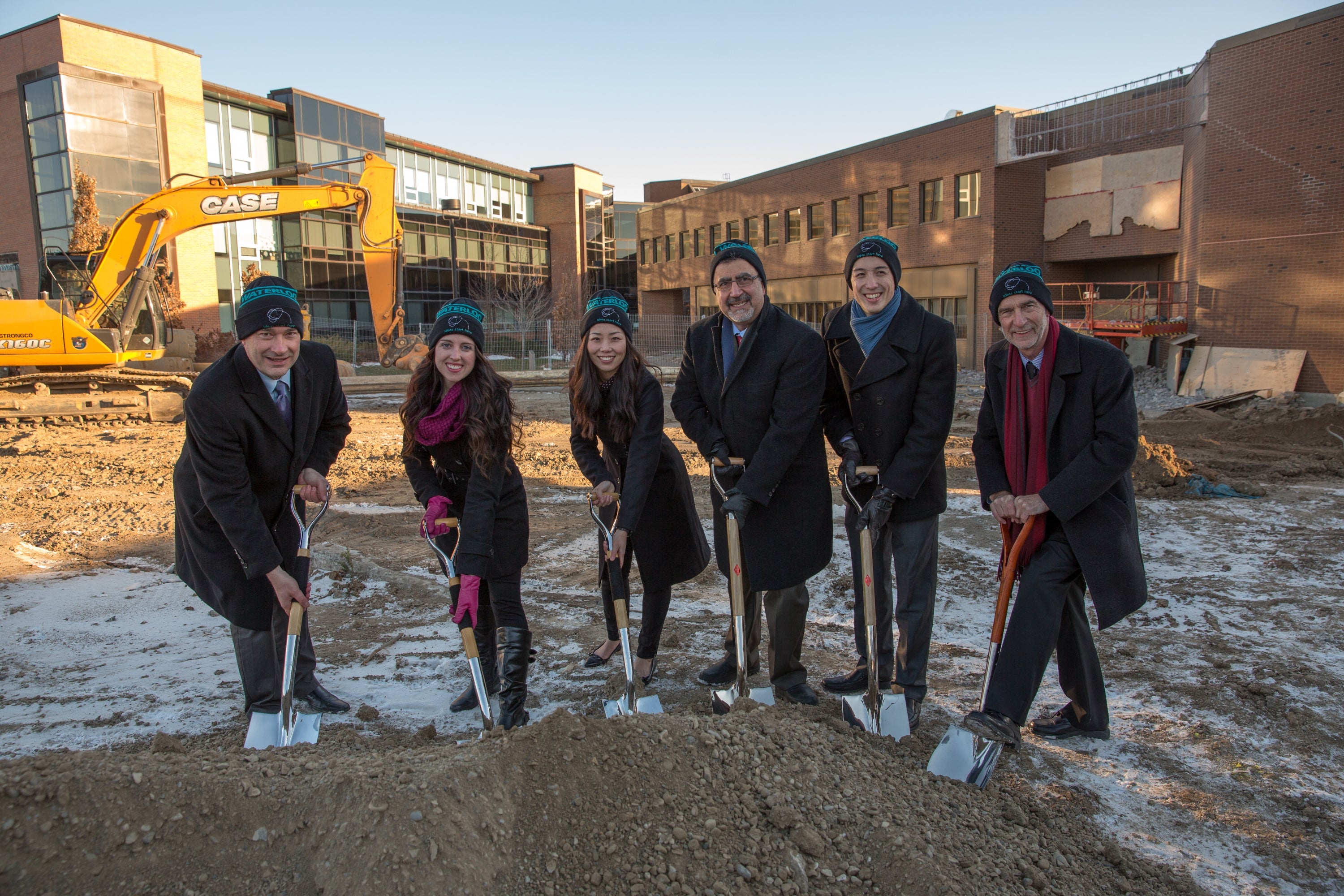 James Rush, Feridun Hamdullahpur, Ian Orchard and student representatives, wearing their AHS toques, with shovels in the ground.