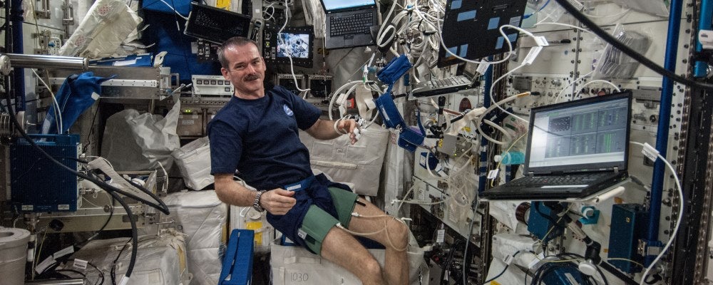RetiChris Hadfield wears blood pressure cuffs on thighs onboard the International Space Station.