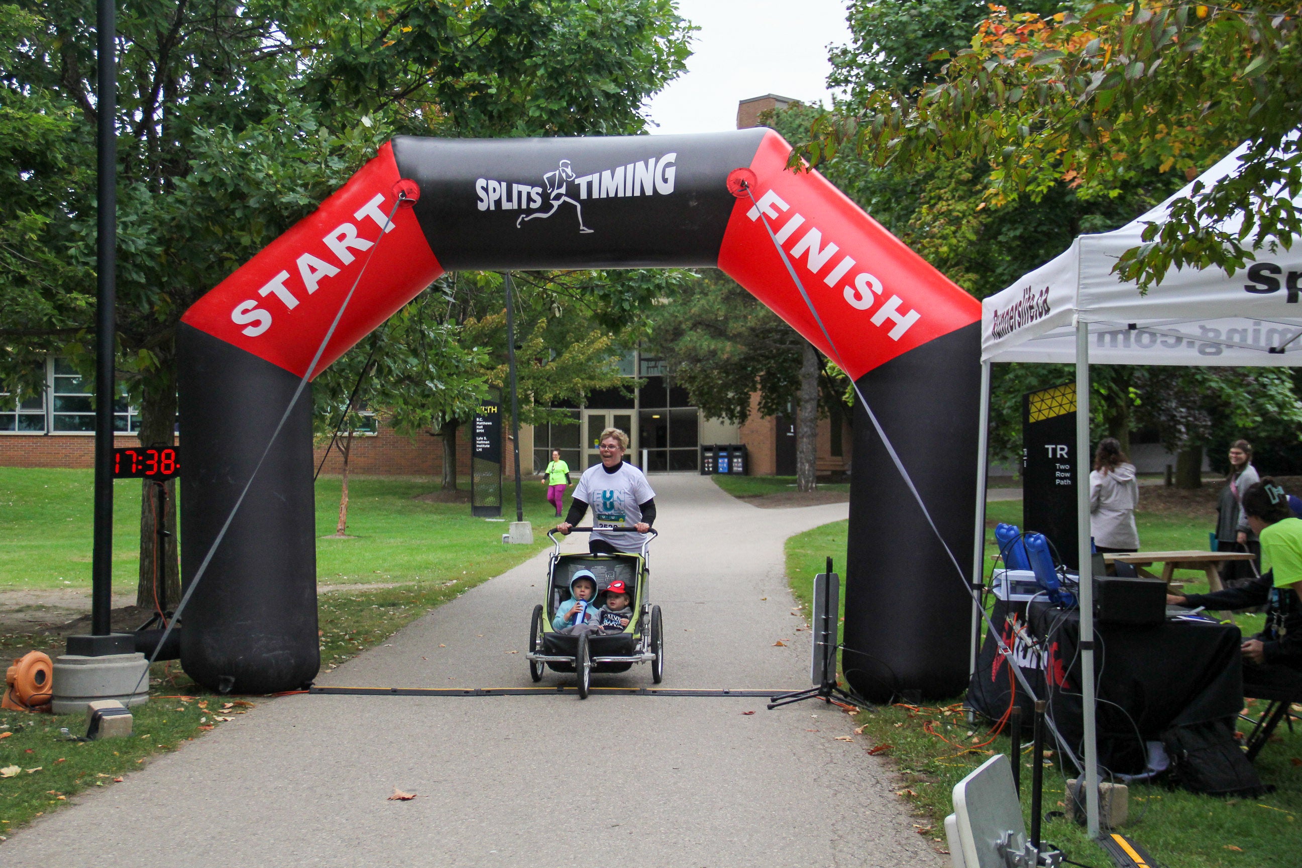 Faculty of health member Julie at finish line with stroller