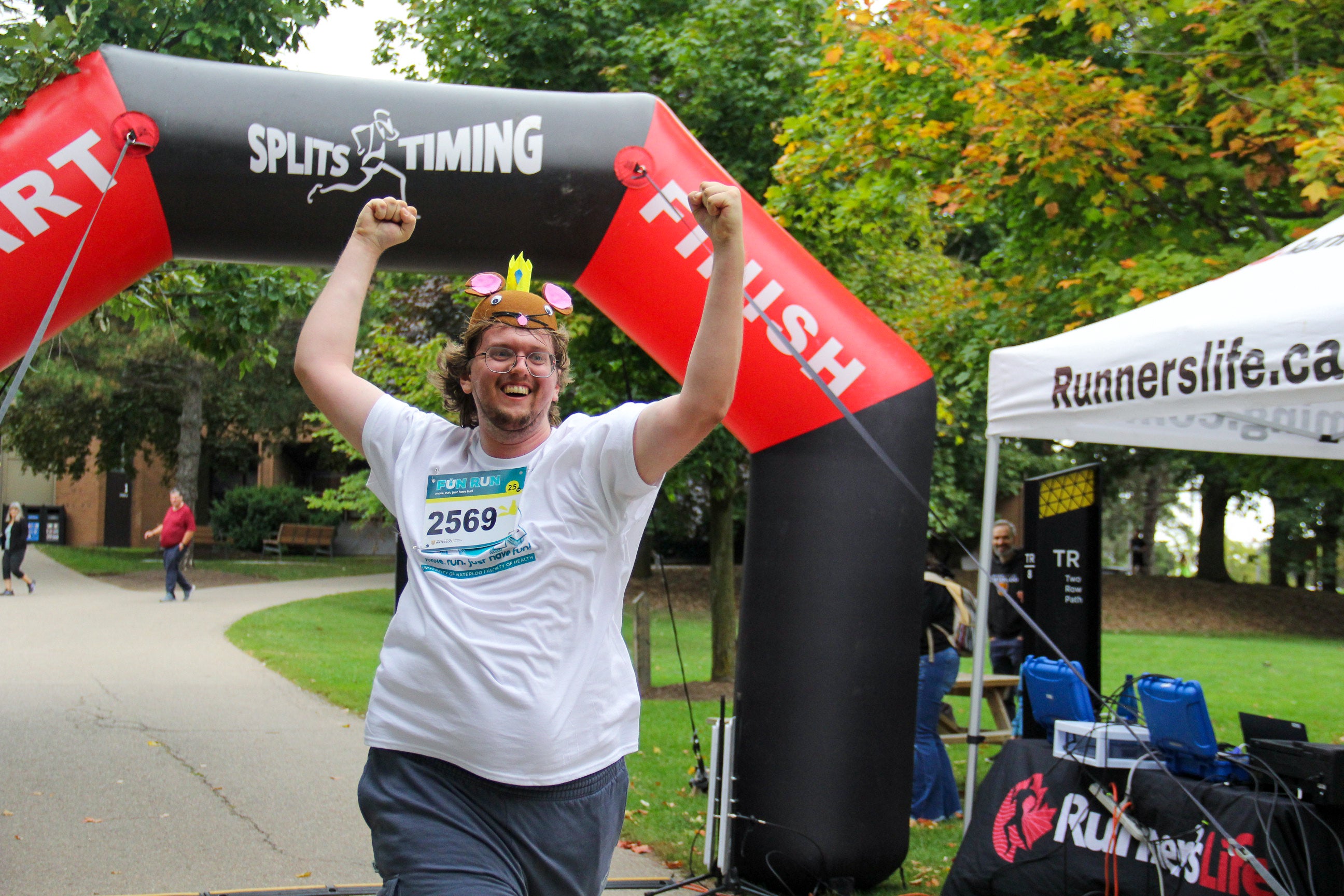 runner with mouse costume cheering at finish line