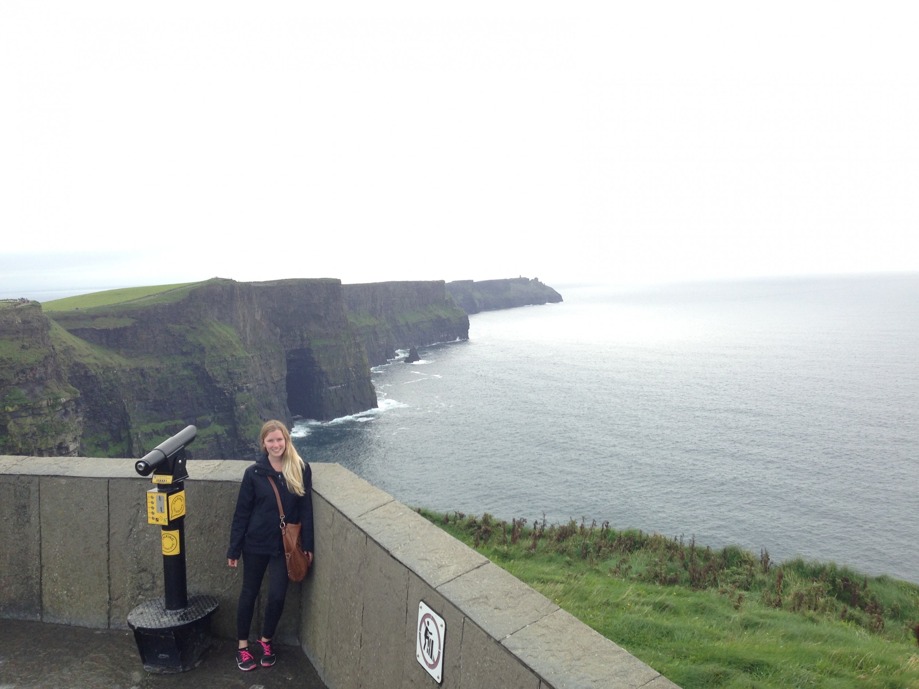 Tess standing near a cliff