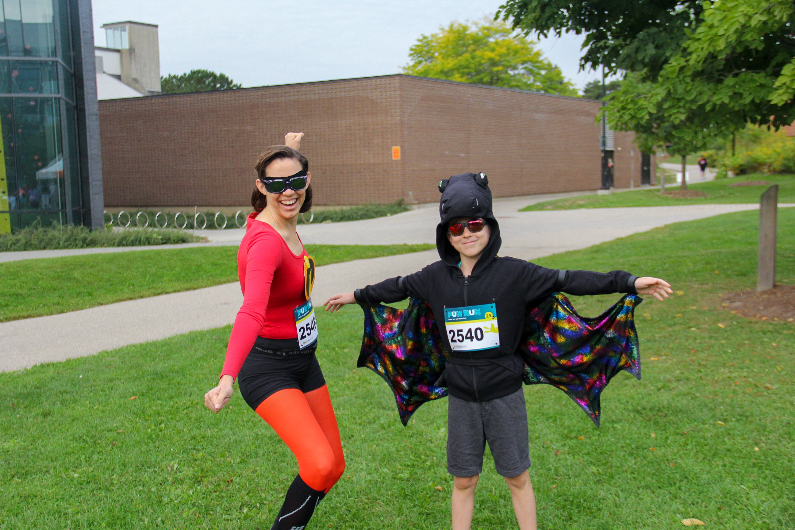 Incredible woman costume posing with kid batman costume