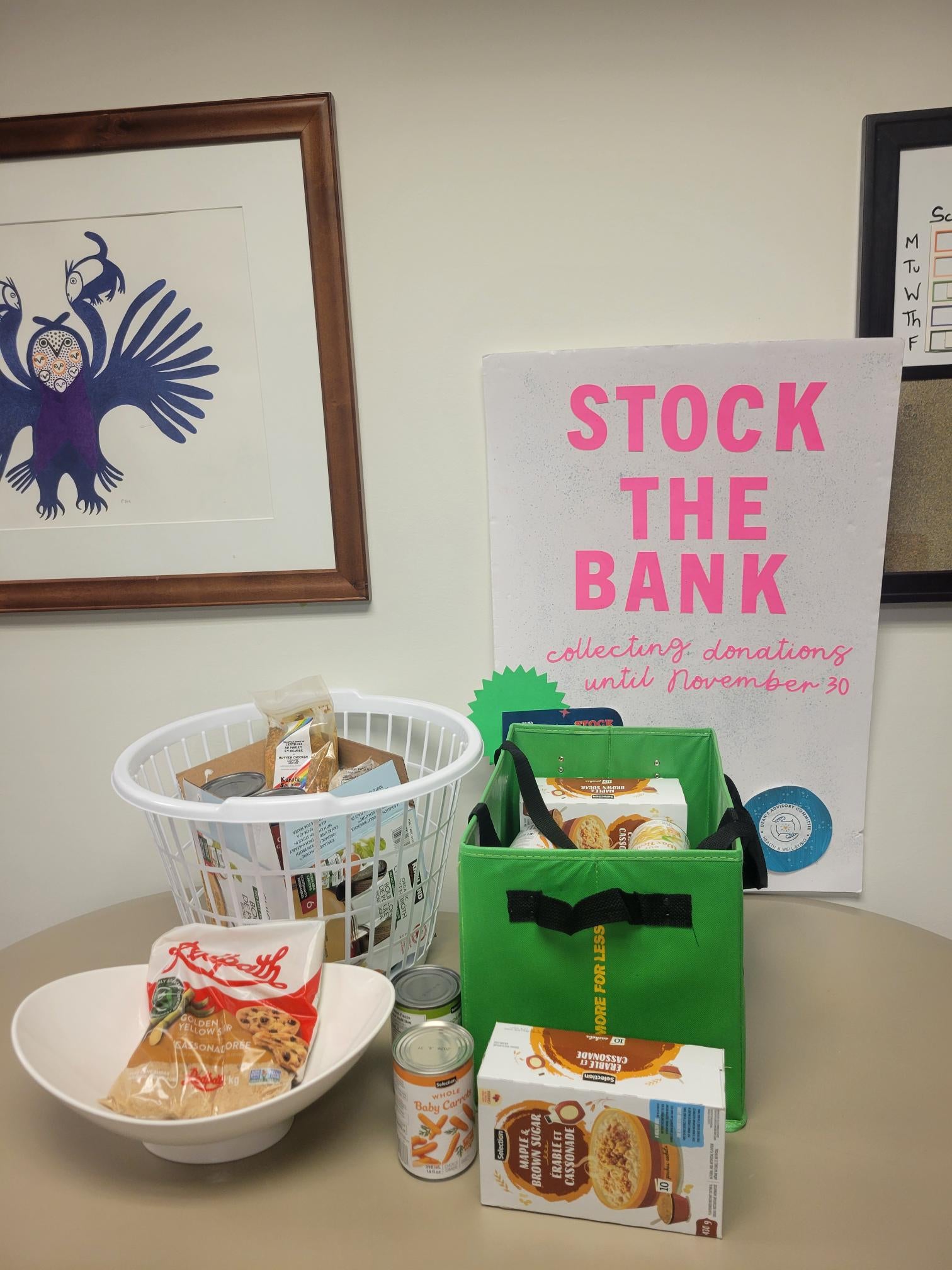 Stock the Bank sign with food donations on a table.