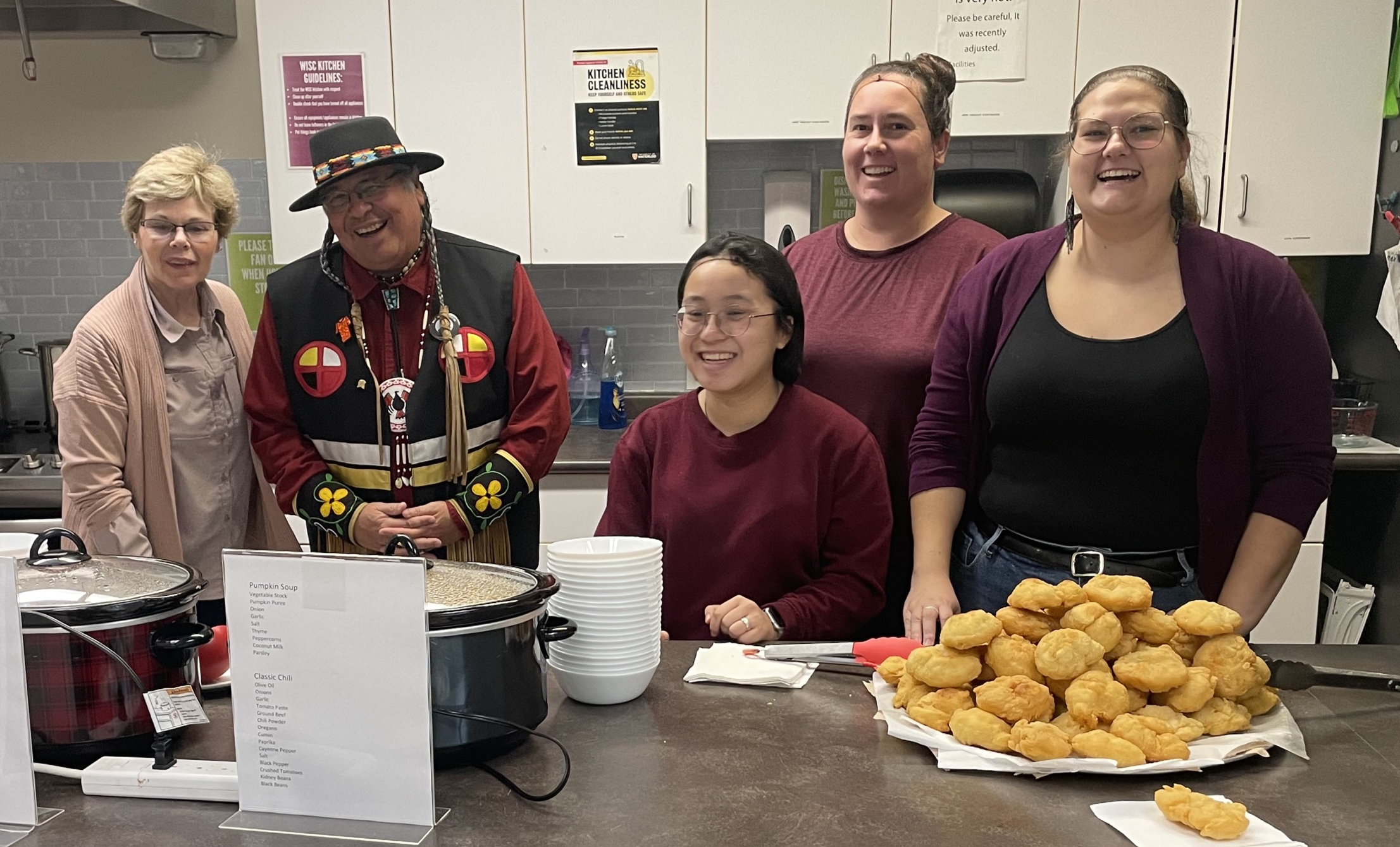 Dean's office members in the kitchen with the prepared bannock and soups.