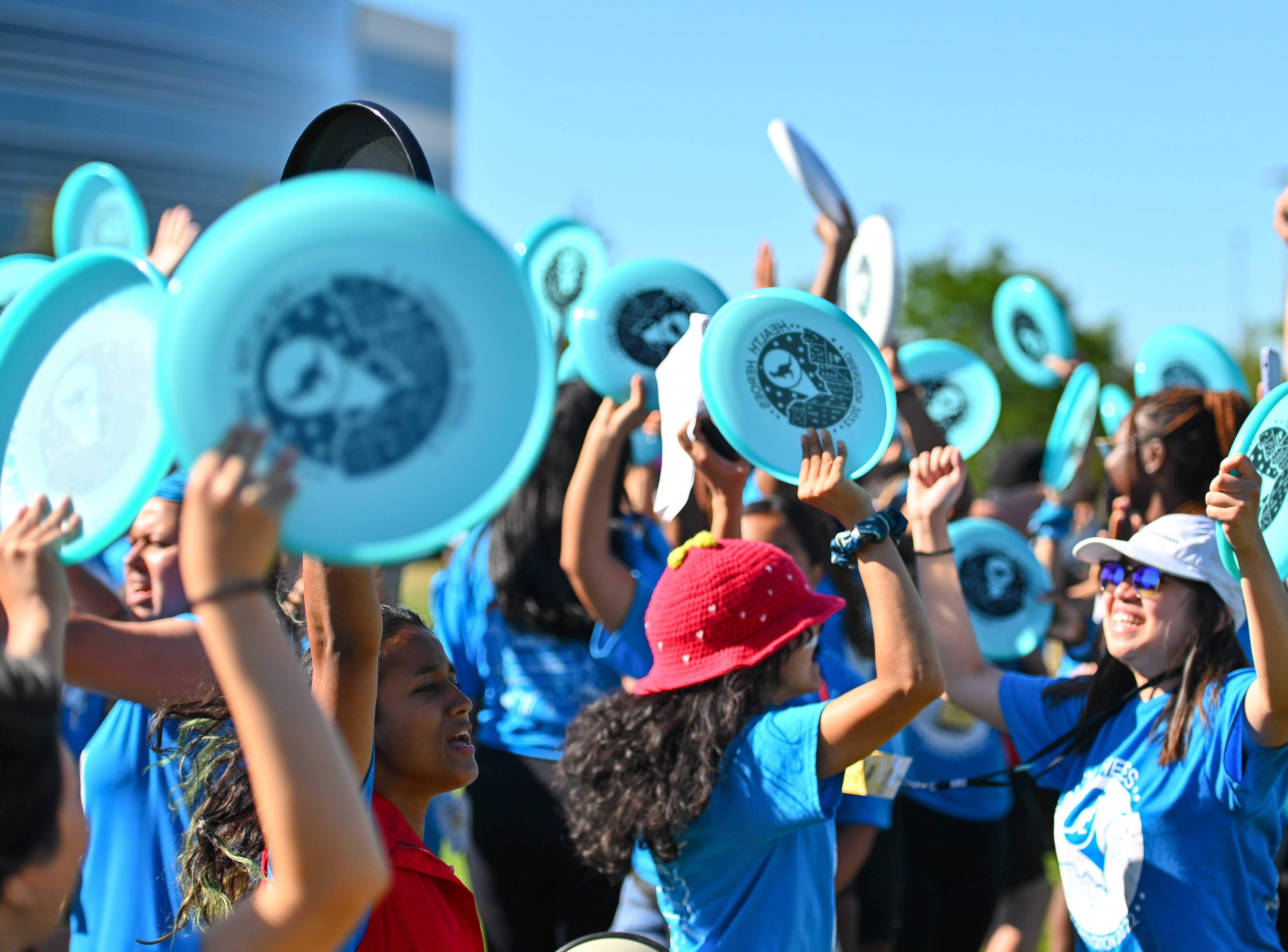 Students holding frisbees at orientation