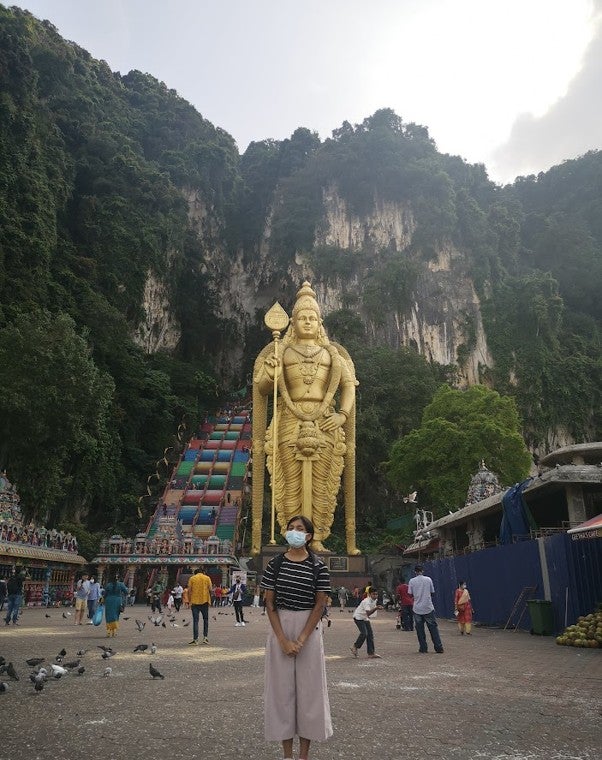 Standing in front of Lord Murugan’s statue