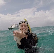 Meghan snorkeling in the sea holding jelly fish