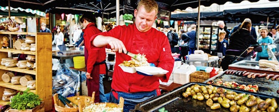 chef serving food at outdoor market