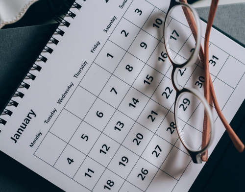 Calendar with glasses on top.