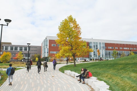 campus landscape with students walking by 