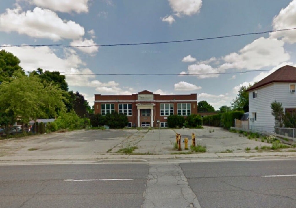 Neglected Lambeth School building in degraded parking lot, London, Ontario 