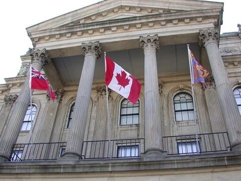A frontage of a stone Portico of Victoria Hall in Cobourg, Ontario