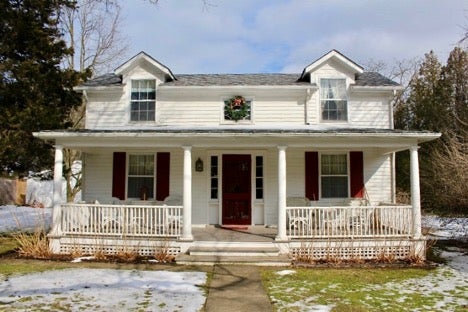 house with dark red door and white exterior