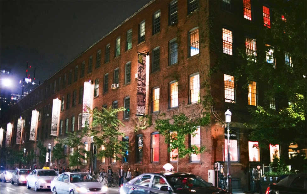 An image of a red brick building on a busy street at night, 401 Richmond