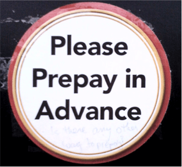 An image of the words "Please Prepay in Advance" on a sticker