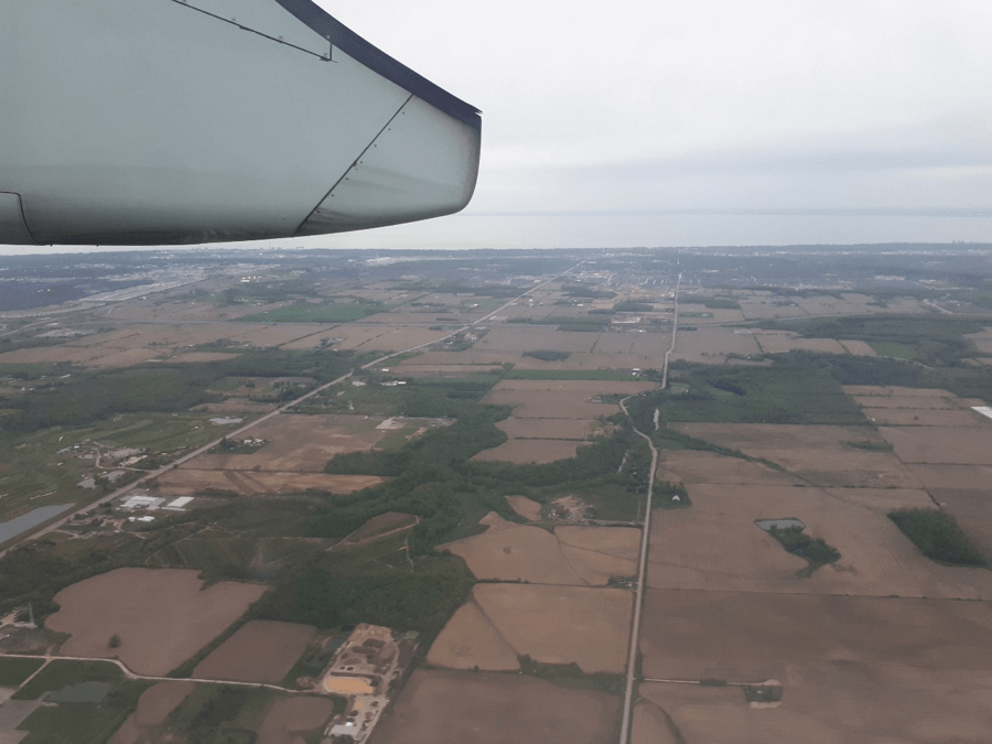 An aerial view from an airplane of Ontario's countryside including farmland and water