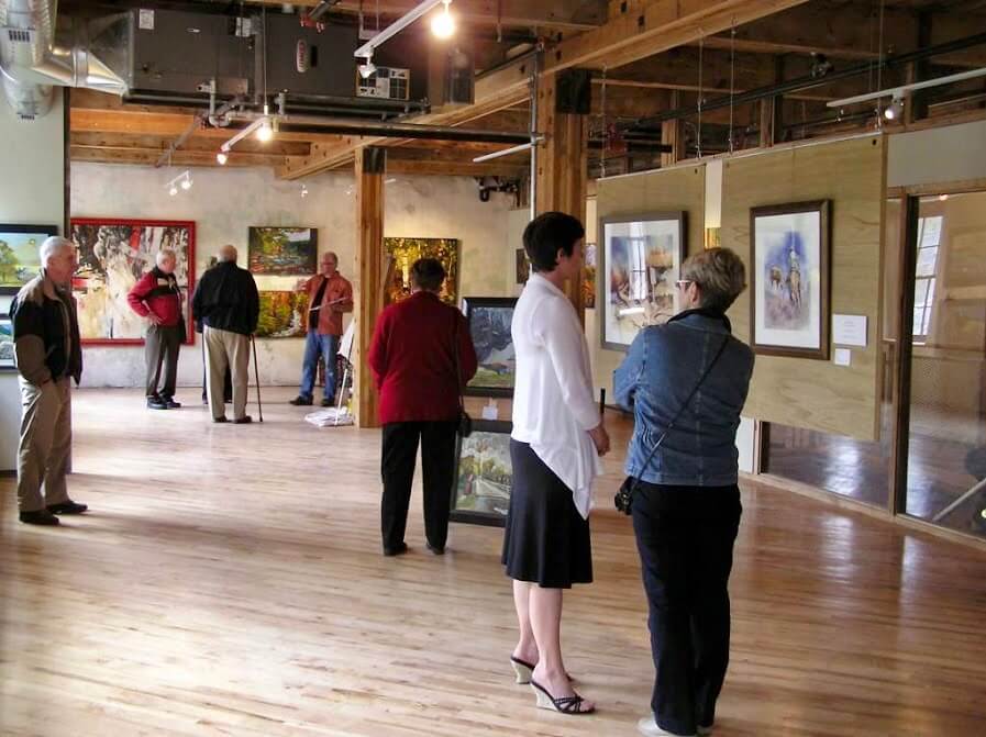 People enjoying an art gallery inside the Alton Mills Art Centre, Alton.