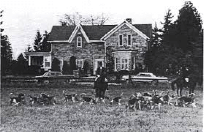 A black and white image of a farm house