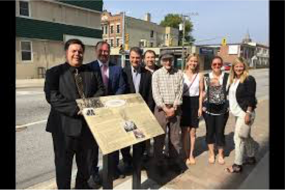 A picture of the Northbay Municipal Heritage Committee with a plaque