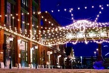 Toronto's distillery district centre at night lit up by white christmas lights