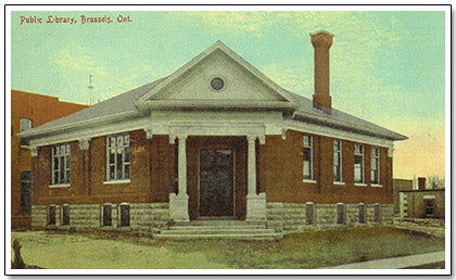 An old postcard showing a building at an intersection.