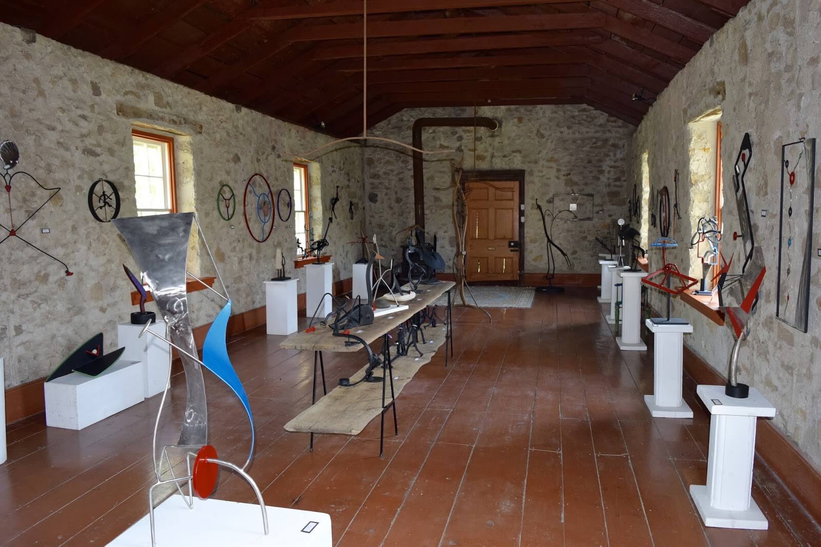 An image of the interior of the Gynasium of the Rockwood Academy, a large gallery displaying sculptures