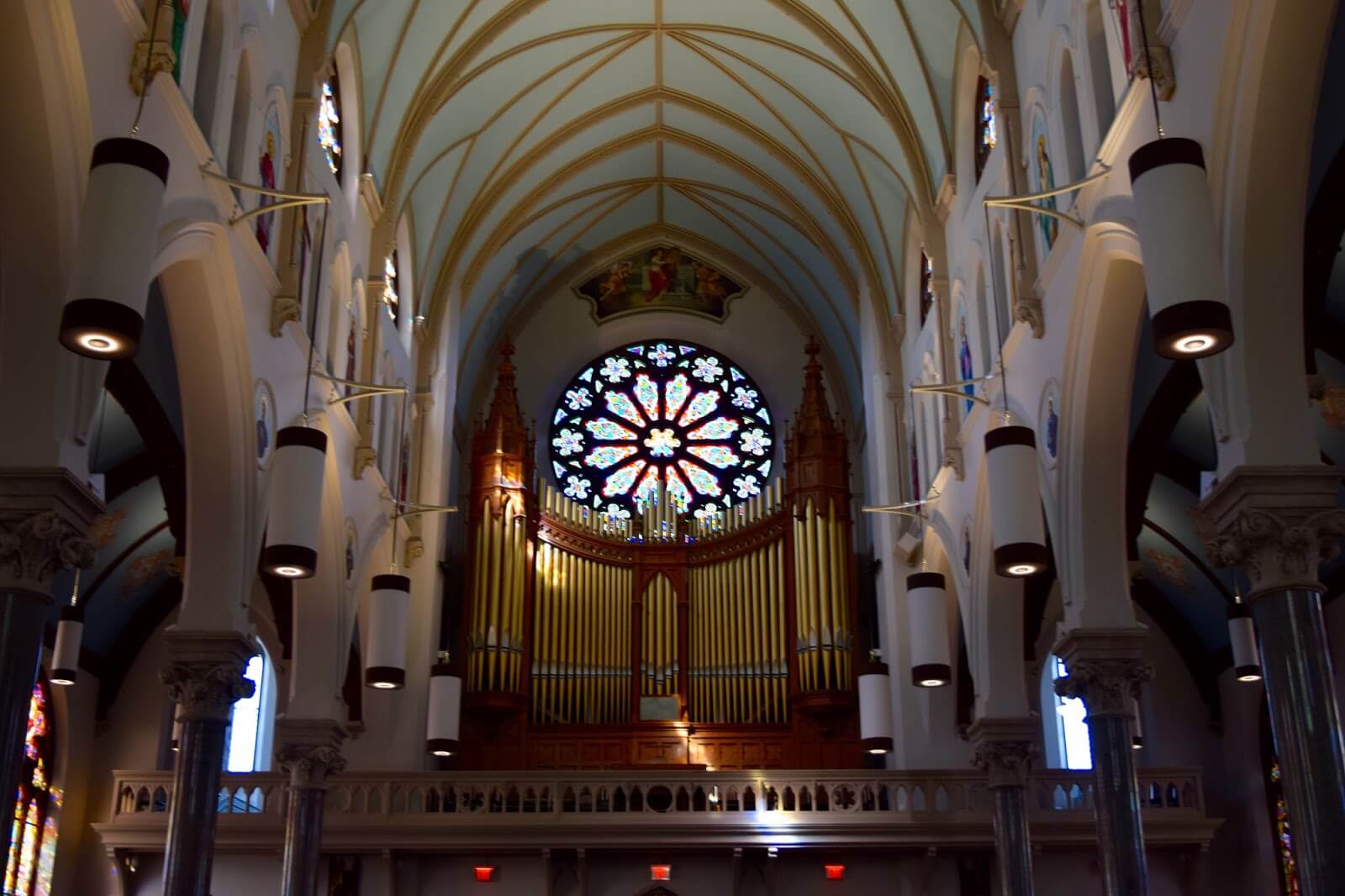 The inside of a church looking at the pipe organ.